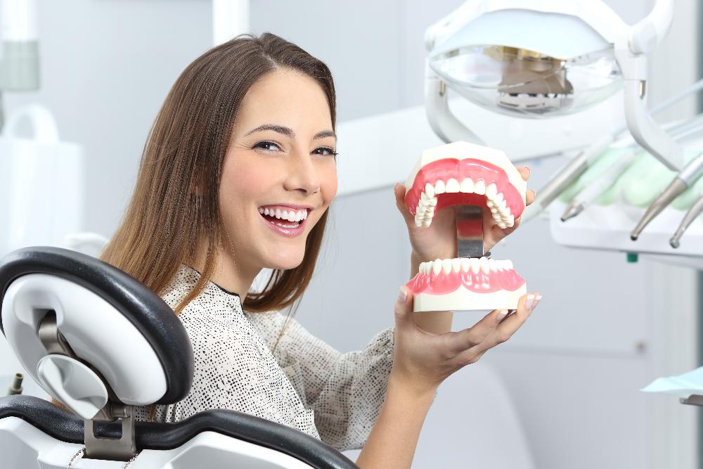 woman holding a tooth model